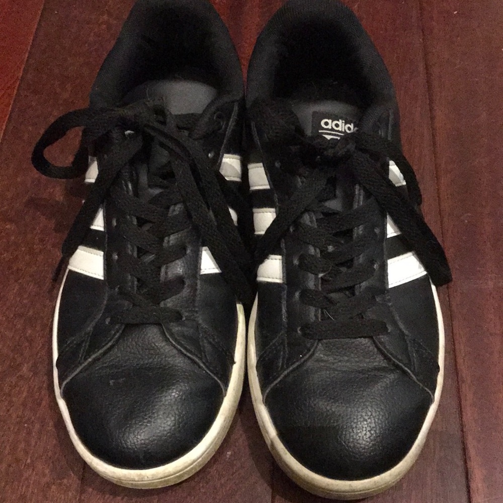 Black adidas with white stripes